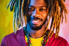 Firefly-bueatiful-black-man-with-afro-dreadlock-hair-dressed-in-complimental-color-clothing-photogr